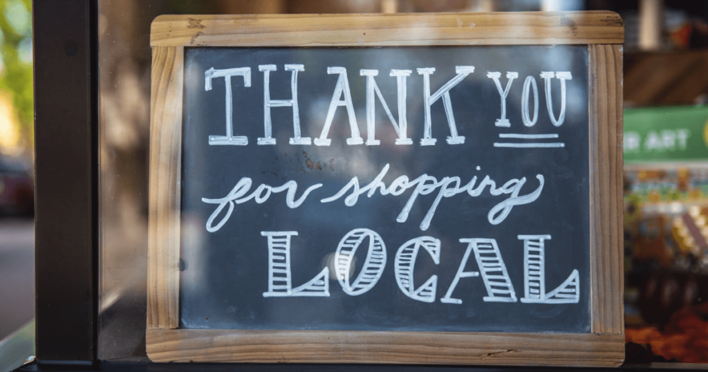 Best local SEO services 2 A small blackboard that has "Thank you for shopping local" written on it.